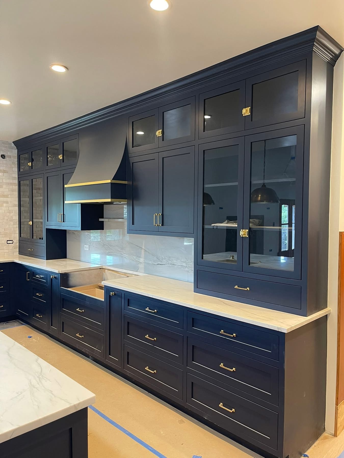 Dark navy custom cabinetry with gold hardware