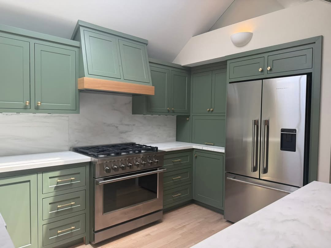 Sage green kitchen with wood accents